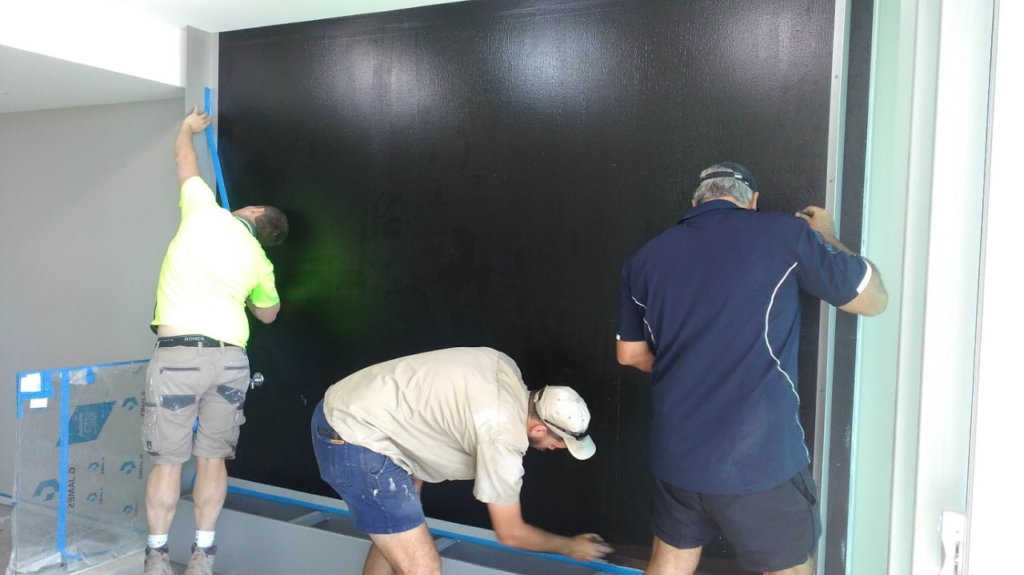 Waterproofing of a green wall area prior to installation.